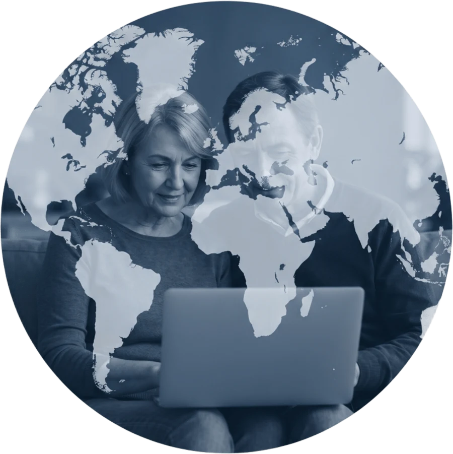 A couple looking up the origins of their family name on a laptop, over a map of the world